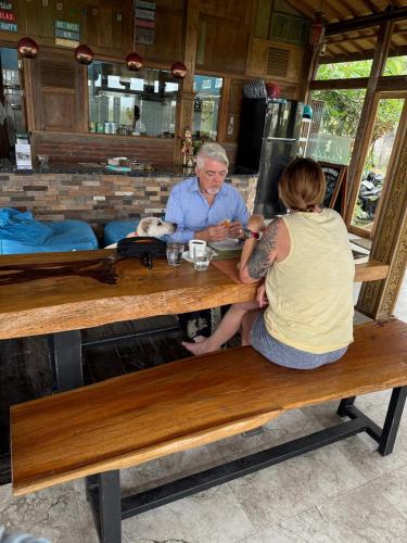 a man and a woman sitting at a table at PINOKKIO B&B Restaurant in Jimbaran