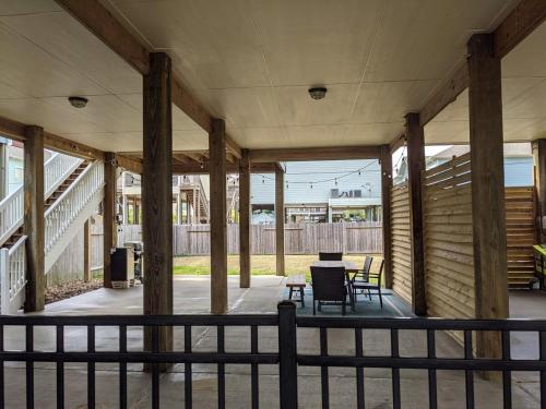 a porch of a house with a table and chairs at Portofino Seaside Escape - 3 Bdr - Kemah in Seabrook