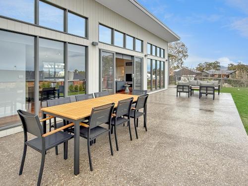 a wooden table and chairs on a patio at The Iron Pear - Pet Friendly with Country Views in Mansfield