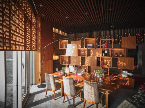 a dining room with a wooden table and chairs at Park Hyatt Seoul in Seoul