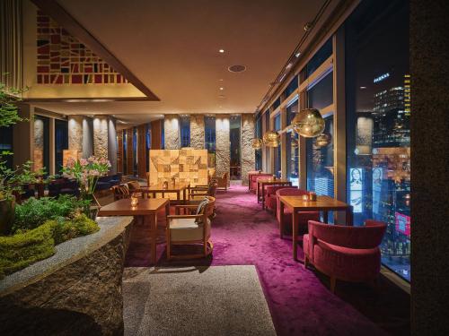 a restaurant with tables and chairs in a room at Park Hyatt Seoul in Seoul