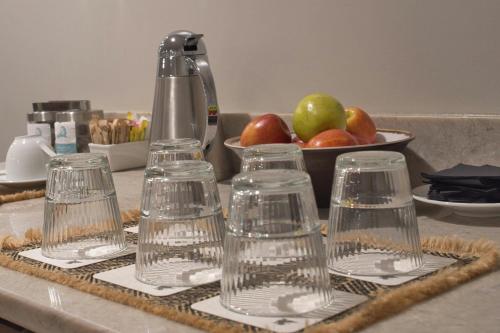 a group of wine glasses on a counter with a bowl of apples at JW Marriott St Maarten Beach Resort & Spa in Dawn Beach