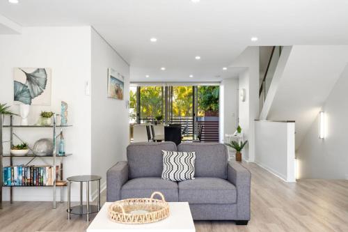 a living room with a couch and a table at Waterline 102 in Forster