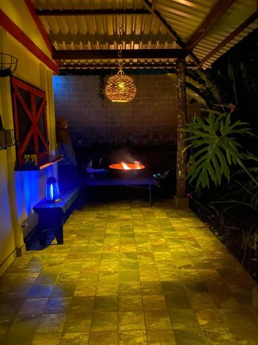 a fireplace in a room with a fire pit at night at Jicote cabañas in Paraíso