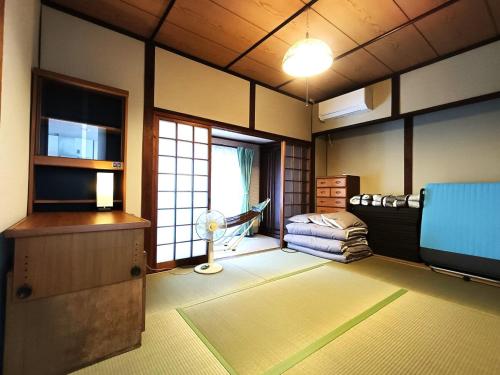 Postel nebo postele na pokoji v ubytování させぼ旅の宿KawashimoEn