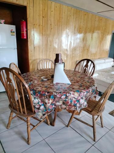 a dining room table with chairs and a blender on it at Dreaming Dawn in Tofoa