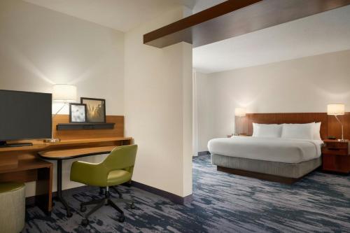 a hotel room with a bed and a desk with a computer at Fairfield Inn & Suites by Marriott Bristol in Bristol