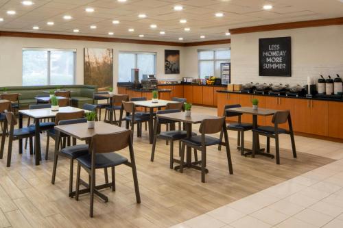 a dining area with tables and chairs in a restaurant at Fairfield Inn and Suites Atlanta Airport South/Sullivan Road in Atlanta