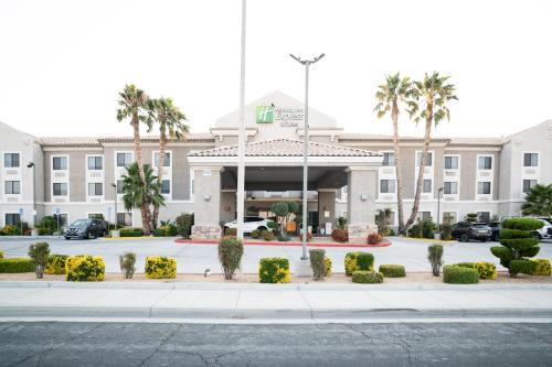 a hotel front of a building with palm trees at Holiday Inn Express Hotel & Suites Hesperia by IHG in Hesperia
