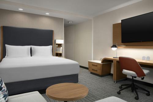 a hotel room with a bed and a desk at Courtyard by Marriott El Paso East/I-10 in El Paso