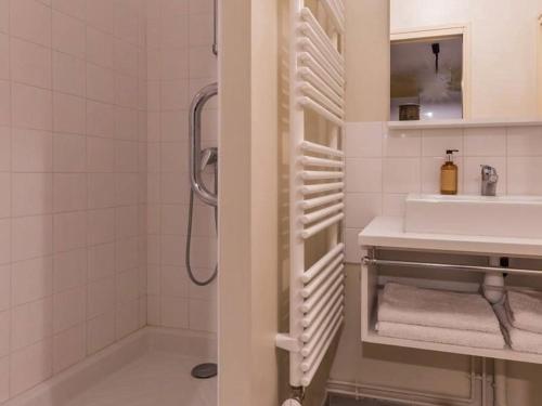 a white bathroom with a sink and a shower at Charmant appartement historique à Vesoul, avec WIFI et parking - FR-1-583-508 in Vesoul