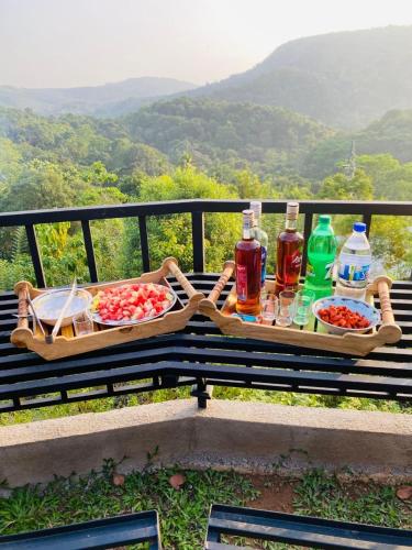 two baskets of food and drinks sitting on a bench at Gold Field Villa in Koslanda
