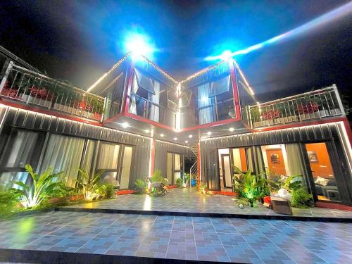 a house with a lit up facade at night at Sea la vie - Do Son Beach Homestay in Ðố Sơn