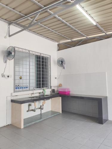 a bathroom with a sink and a mirror at Tracy Homestay Tmn Indah Jaya in Sandakan