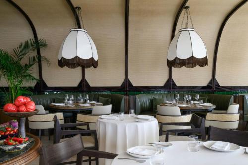 a dining room with tables and chairs and chandeliers at Praia D'El Rey Marriott Golf & Beach Resort in Casal da Lagoa Seca
