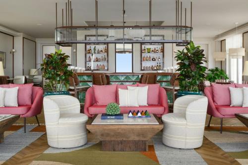 a living room with pink and white furniture at Praia D'El Rey Marriott Golf & Beach Resort in Casal da Lagoa Seca