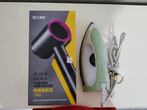 a picture of a hair dryer next to a box at Tracy Homestay Tmn Indah Jaya in Sandakan