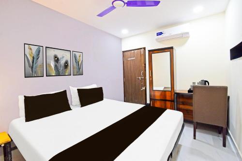 a bedroom with a bed and a dresser in it at Collection O Jagadgirigutta Road in Hyderabad
