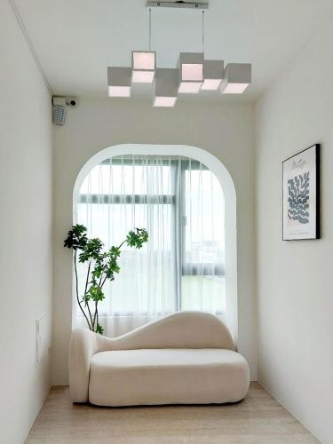 a white couch in a room with a window at 慢慢三星民宿 ChillaxSanxing B&B in Sanxing