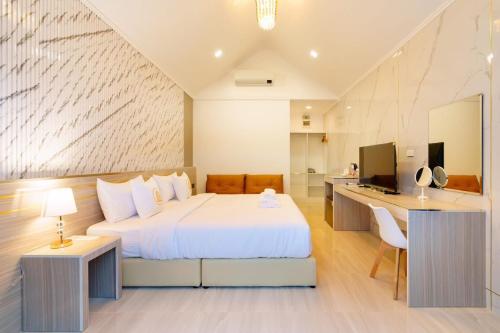 a hotel room with a bed and a desk at i2 Resort Lampang in Sathani Nakhon Lampang