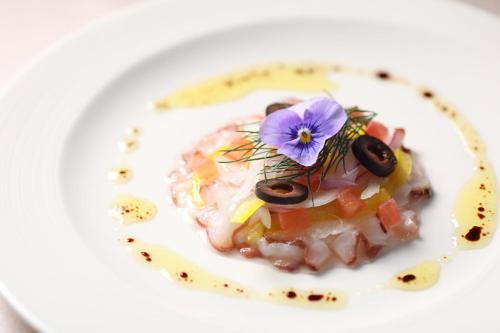 a plate of food with a purple flower on it at ANA Crowne Plaza Narita by IHG in Narita