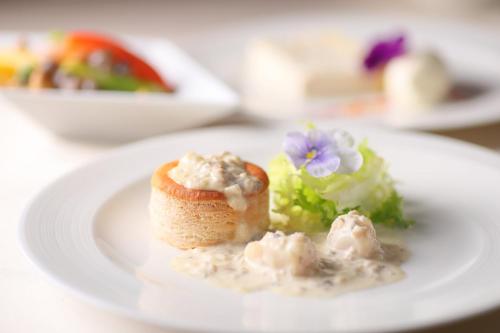 a plate of food with a piece of bread and a salad at ANA Crowne Plaza Narita by IHG in Narita