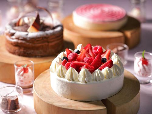 a cake with strawberries and blueberries on a table at ANA Crowne Plaza Narita by IHG in Narita