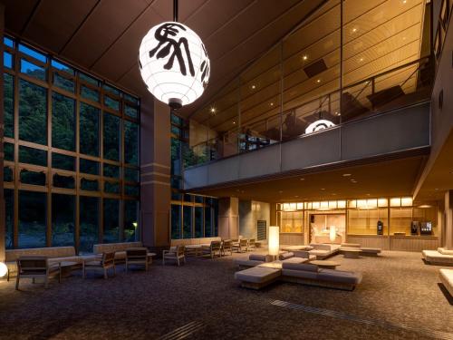 a lobby of a building with couches and a fireplace at KAMENOI HOTEL Arima in Kobe
