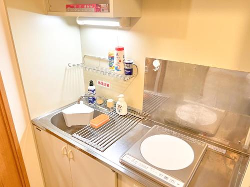 a small kitchen with a sink and a counter top at Stylish ROCO house Omori8min in Tokyo
