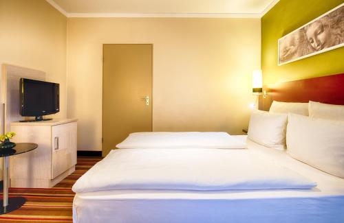 Katil atau katil-katil dalam bilik di Leonardo Hotel & Residenz Muenchen