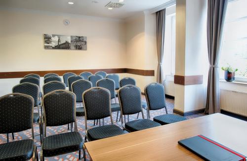a conference room with chairs and a table at Leonardo Hotel Hamburg Stillhorn in Hamburg