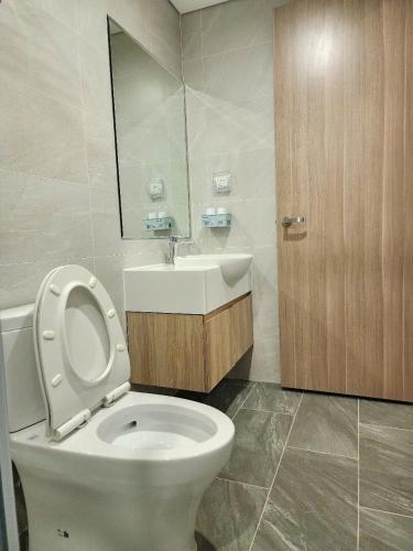 a bathroom with a white toilet and a sink at Smart-SA51920 in Phú Thú