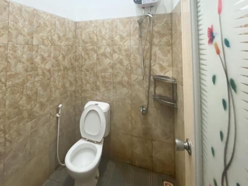 a bathroom with a toilet and a shower at De Zity Syariah RedPartner Near Alun Alun Jember in Jember