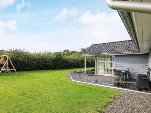 a backyard with a deck and a house at 8 person holiday home in Fjerritslev in Fjerritslev