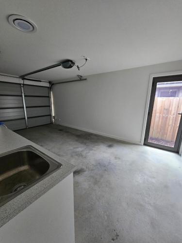 an empty garage with a sink and a window at George Town Villa - Outdoor Alfresco - aircon FREE WIFI - Central location near MTB Trails in George Town