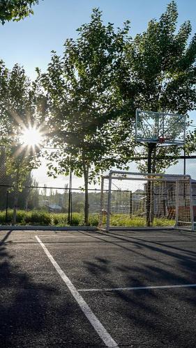an empty basketball court with a net and trees at Blissvale - Celebrations Galore in Dzoraghpʼyur