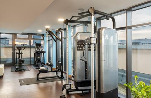 a gym with several tread machines in a building at Leonardo Royal Hotel Berlin Alexanderplatz in Berlin