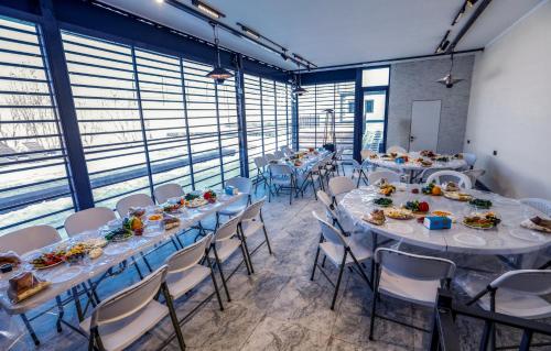 a room with long tables and chairs with food on them at Blissvale - Celebrations Galore in Dzoraghpʼyur