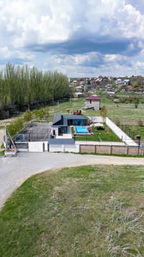 a house with a swimming pool in a field at Blissvale - Celebrations Galore in Dzoraghpʼyur