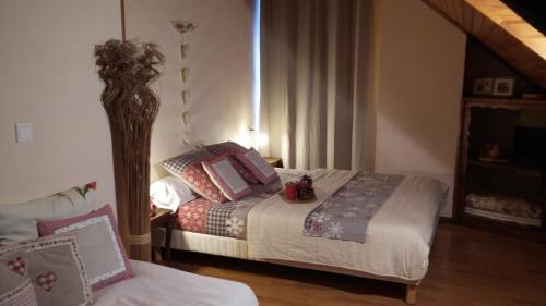 a bedroom with two beds with pillows on them at L'Arcouli in Sers