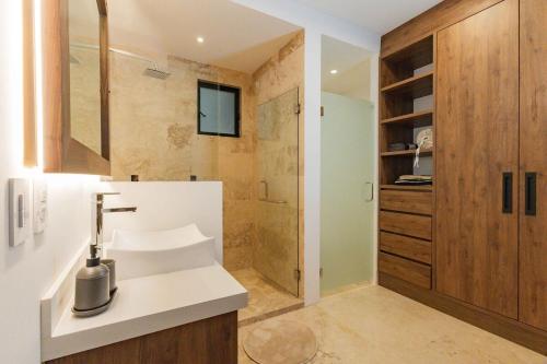 a bathroom with a sink and a shower at Beautiful apartment with a view of the Arch in Cabo San Lucas