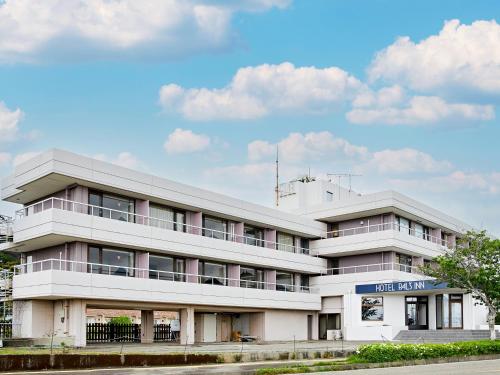 a large white building with a sky at Pals Inn Katsuura in Katsuura