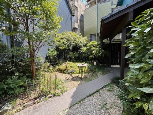 a garden with a table and chairs in front of a building at Nagasaki Kagamiya in Nagasaki