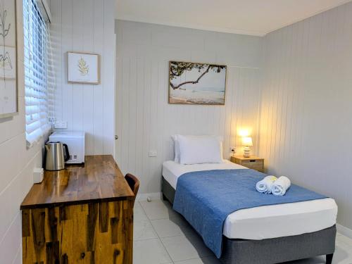 a small bedroom with a bed and a desk at Central Private Bedroom & Ensuite - City & Strand Beach Location in Townsville