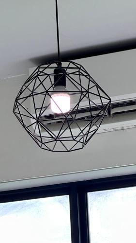 aendant light hanging from a ceiling with two windows at JQ1 SEA & POOL or CITY View WIFI I WASHING MACHINE for Some Units I CUCKOO WATER Jesselton Quay by R2 in Kota Kinabalu