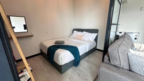 a small bedroom with a bed and a mirror at JQ1 SEA & POOL or CITY View WIFI I WASHING MACHINE for Some Units I CUCKOO WATER Jesselton Quay by R2 in Kota Kinabalu