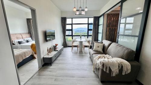 a living room with a couch and a table at JQ1 SEA & POOL or CITY View WIFI I WASHING MACHINE for Some Units I CUCKOO WATER Jesselton Quay by R2 in Kota Kinabalu