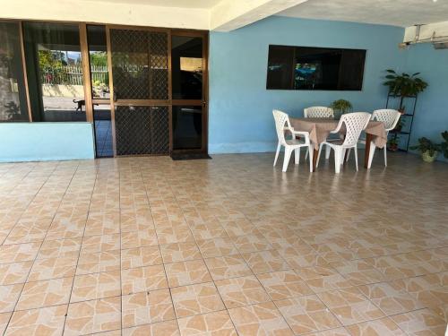 a patio with a table and chairs on a tiled floor at Libby's Vacation Rental 2 Bed Home 1-4 Guests in Nadi