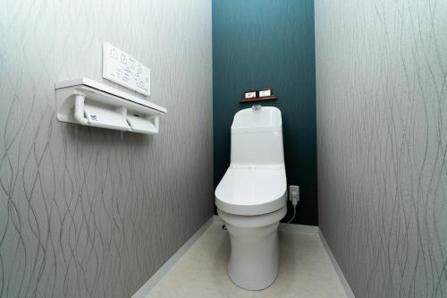 a bathroom with a white toilet in a stall at 三十三Inari in Kyoto