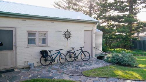 two bikes parked against the side of a house at Chiton Cottage by the Sea - Restaurants, Bikes, Pets in Hayborough